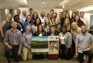 Photo of a past RSLC cohort standing in an odic holding an RSLC sign