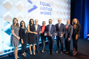 Photo of the 2023 Scales of Justice event participants on stage (L-R) Emily Neely, Kathryn Fritz, Caroline Heller, Cesar Alvarez, Verna Williams, Diego Cartagena, Jim Chosy, Garry Jenkins, and Jaden Lajyll Zwick Ojeaburu