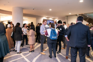 Photo of the Alumni-Fellow Welcome Reception, a crowd of Fellows, alumni, program participants, and Equal Justice Works staff stands around networking and chatting.