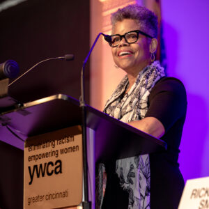 Photo of Verna Williams standing at the podium and sharing her remarks at the 2023 YWCA Racial Justice Breakfast