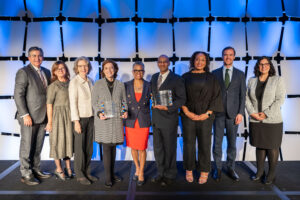 2024 Scales of Justice program participants stand on stage together after the show (L-R) Frank Jimenez, Kate Fritz, Caroline Dorsa, Susan Alexander, Verna Williams, Ahilan Arulanantham, Valencia Richardson, Malcolm Lloyd, and Carmen Iguana Gonzalez.