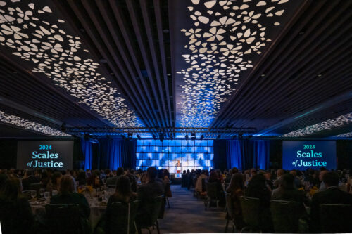 Wide shot of the room at the Scales of Justice 2024. Verna Williams stands on stage in front of an audience.
