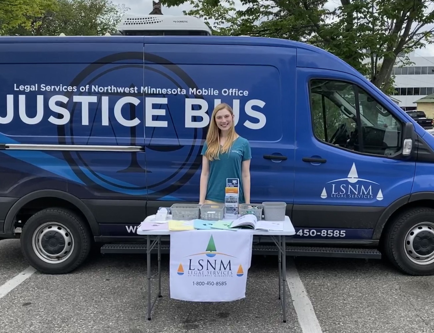 Kelsey Gunvalson standing outside of the Justice Bus, a mobile method of delivering legal services to communities who otherwise don't have access to such resources.