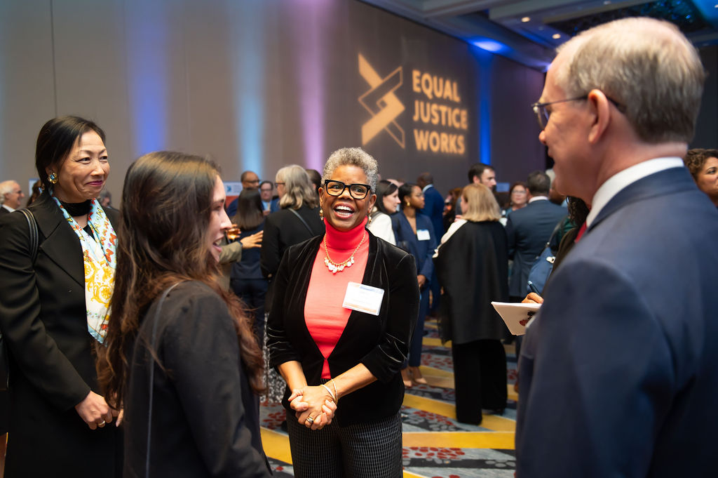 Photo of Verna Williams speaking with a group of event attendees and community supporters at the pre-event reception for the 2023 Scales of Justice.