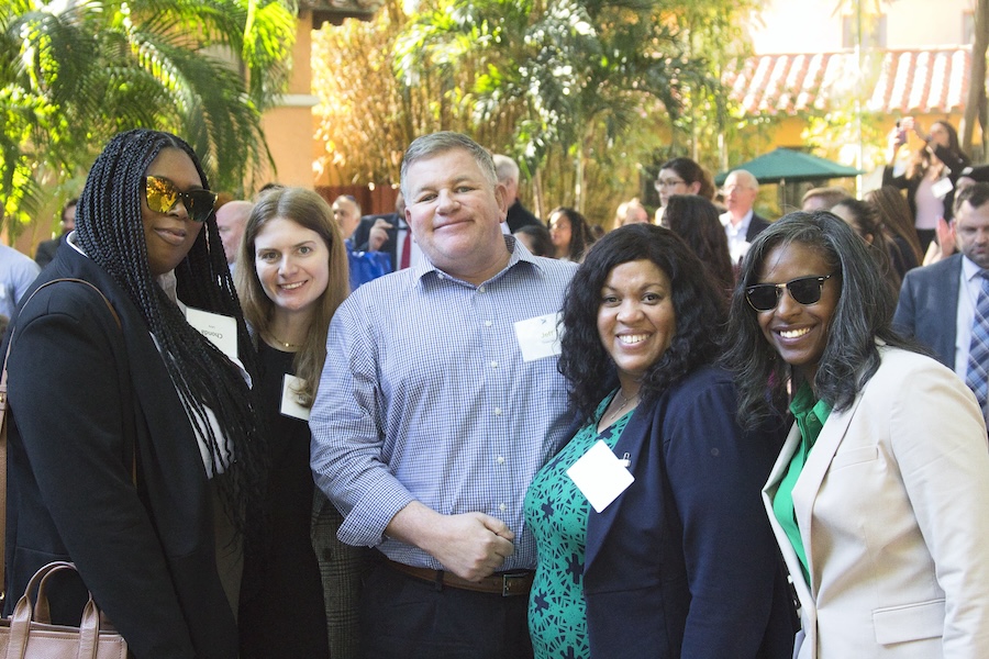 Attendees of the 2023 Disaster Resilience Symposium stand together for a photo at the event reception