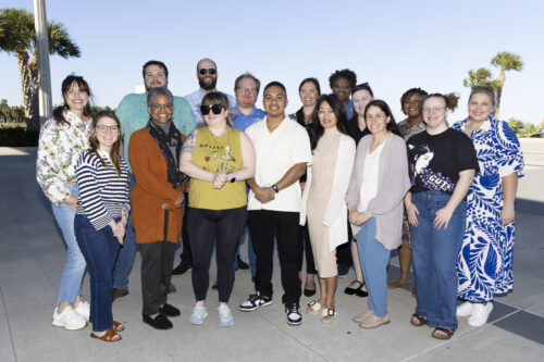 Photo of Equal Justice Works staff with Disaster Resilience Program Fellows at the 2025 Disaster Resilience Symposium welcome reception. The group of 15 stands together outside on a pier.