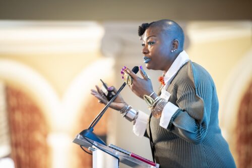 Photo of Natasha standing speaking at the podium at 2025 LDT