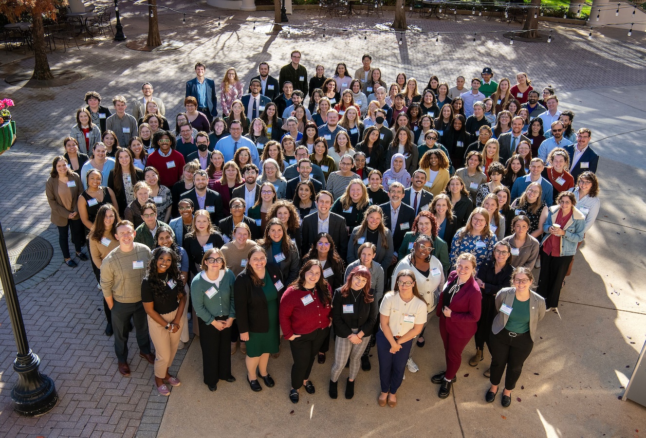 Group photo of 2025 Fellow attendees of Leadership Development Training standing outside and smiling together